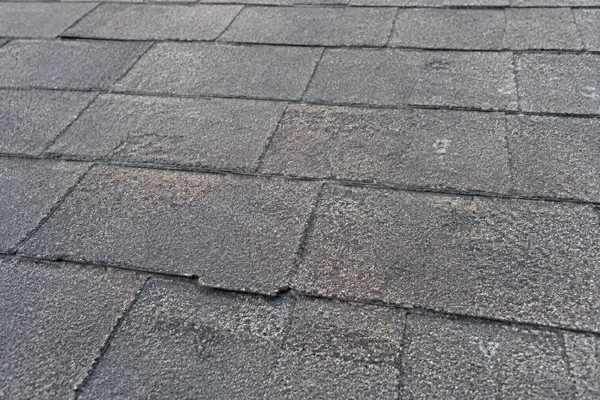 Illustration of diffuse granule loss and normal weathering on older asphalt shingles